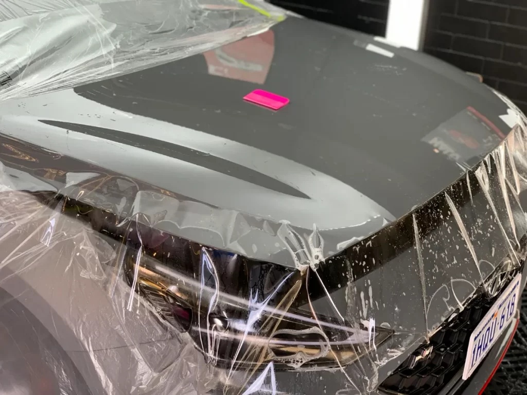 A car hood wrapped with Paint Protection Flm