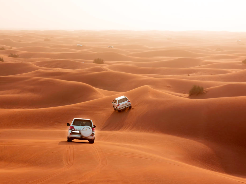 Two cars driving in a dessert